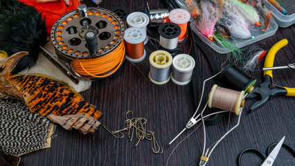 A set of various accessories and materials for tying flies for fly fishing. Close-up.