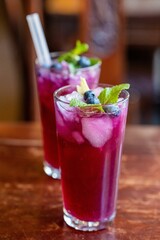 Fresh lemonade with blueberries and mint on a wooden table