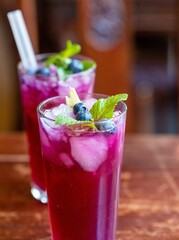 Fresh lemonade with blueberries and mint on a wooden table
