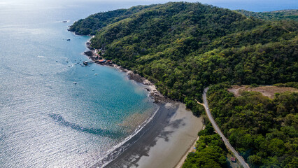 Aerial waves, Aerial Drone View of a tropical island with lush jungle in Costa Rica, Isla del Caño, Beautiful view of boats