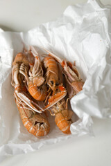 Fresh crayfish langoustine from fish market on tabel in kitchen