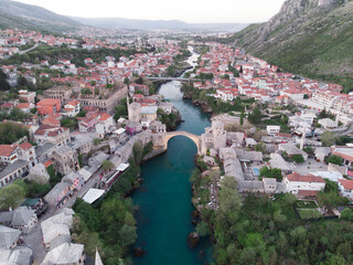 erial Mostar Bridge and Koski Mehmed Pasha Mosque drone view of the historical city of Mostar,...