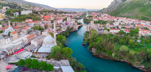 erial Mostar Bridge and Koski Mehmed Pasha Mosque drone view of the historical city of Mostar,...