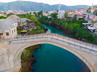 erial Mostar Bridge and Koski Mehmed Pasha Mosque drone view of the historical city of Mostar,...
