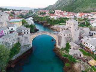 Fotobehang Stari Most erial Mostar Bridge and Koski Mehmed Pasha Mosque drone view of the historical city of Mostar, Ottoman architecture view of Bosnia is the most beautiful city in Europe