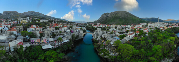 erial Mostar Bridge and Koski Mehmed Pasha Mosque drone view of the historical city of Mostar,...