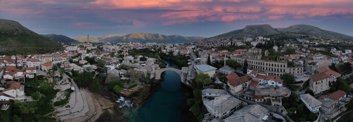 erial Mostar Bridge and Koski Mehmed Pasha Mosque drone view of the historical city of Mostar,...