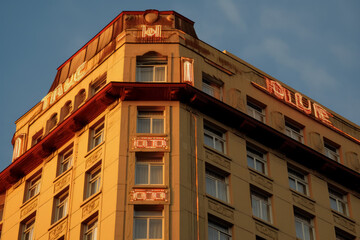 Fototapeta na wymiar Hotel building, 9th-century style, art deco sensibilities, light red and bronze. Generative AI. 