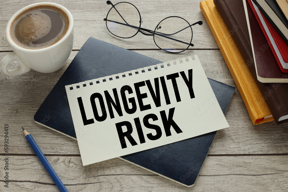 Poster longevity risk. text on notepad with spring. near glasses.