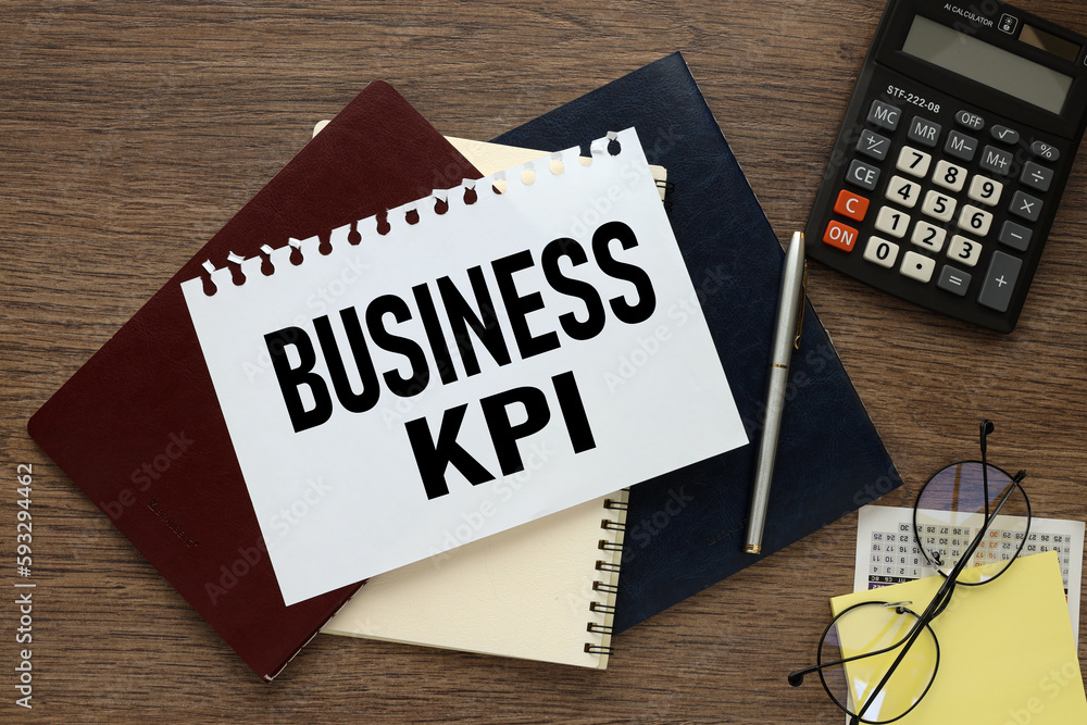 Aufkleber business kpi three notebooks on the table and a torn page with text