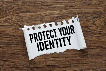 Protect Your Identity torn notepad paper with text on wooden background