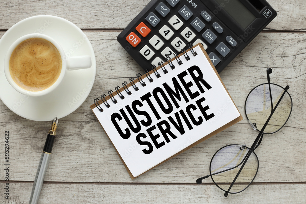 Poster customer service text on notepad with spring. on a calculator. next to a cup of coffee