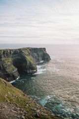 Beautiful vertical seascape with the rocky Cliffs of Moher at the shore, Ireland