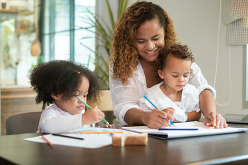 African American mother playing with her daughters in home