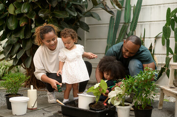 Happy African American family enjoying gardening at home