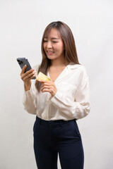 Fototapeta premium Young asian businesswoman holding credit card over white background studio, shopping and finance concept..
