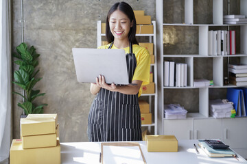 startup girl Small SME business owners work with laptop computers at work. with parcel paper boxes for delivery to customers online selling, Ecommerce,