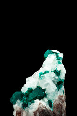 Dioptase crystal on white calcite on black bakcground. macro detail isolated. close-up rough raw...