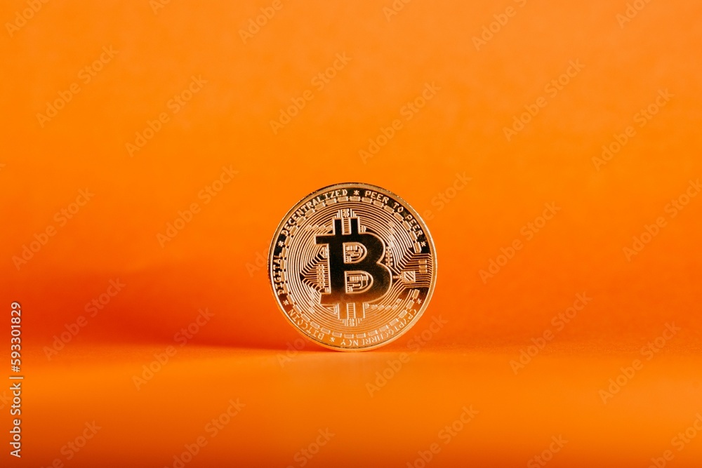 Poster closeup shot of a bitcoin isolated on an orange gradient background