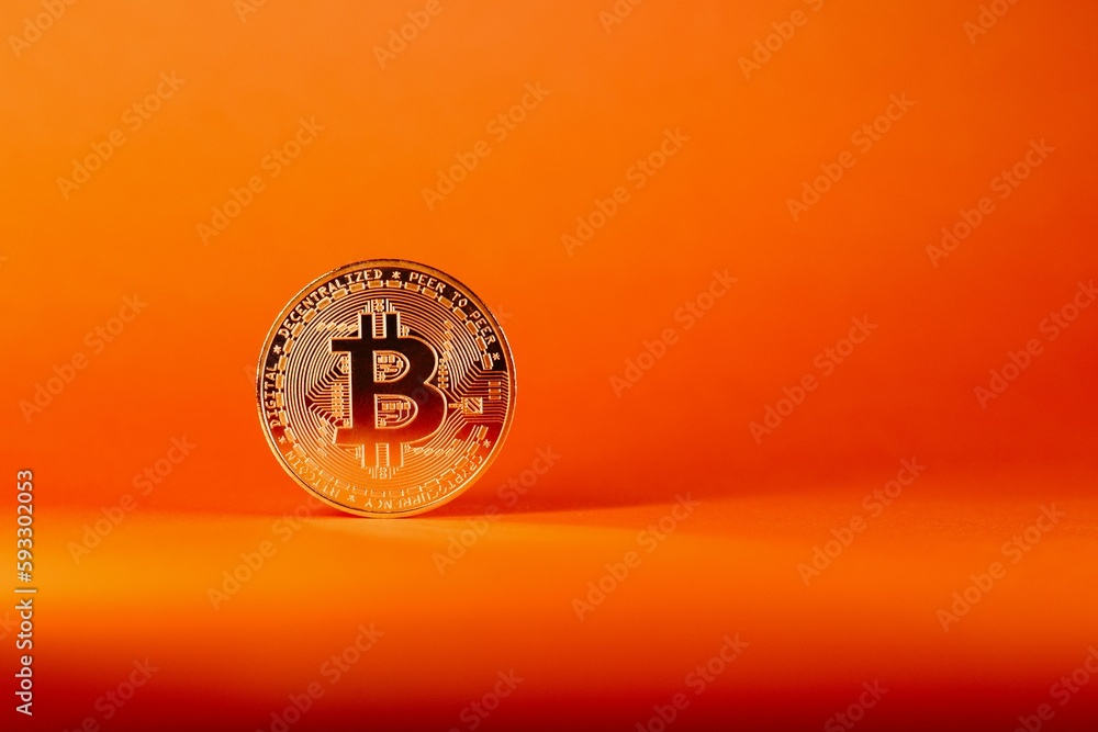 Poster closeup shot of a bitcoin isolated on an orange gradient background