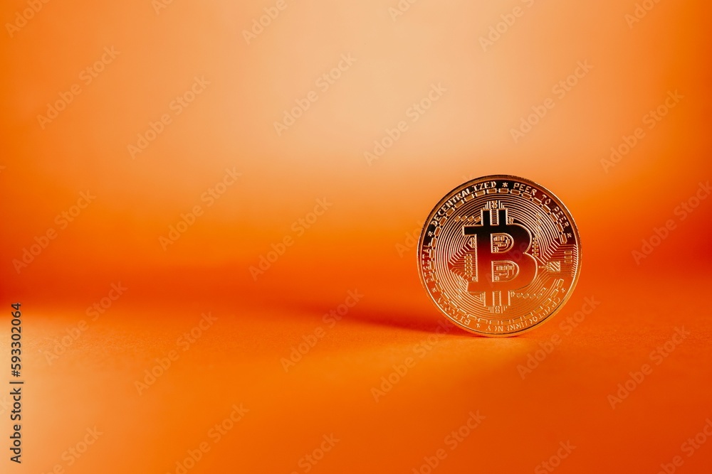 Poster closeup shot of a bitcoin isolated on an orange gradient background