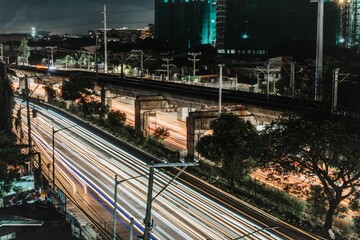 Long exposure urban shot of a street surrounded by modern buildings at night