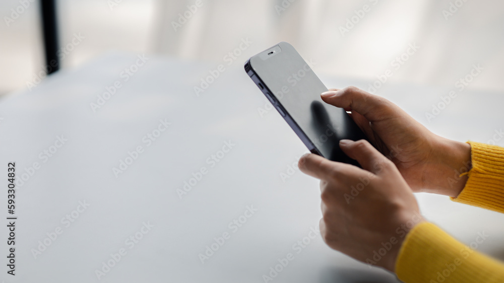 Wall mural a person holds a mobile phone to use social media on a smartphone, communicating via the internet on