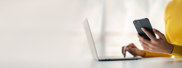 A person holds a mobile phone to use social media on a smartphone, communicating via the Internet...