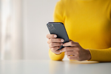 A person holds a mobile phone to use social media on a smartphone, communicating via the Internet...