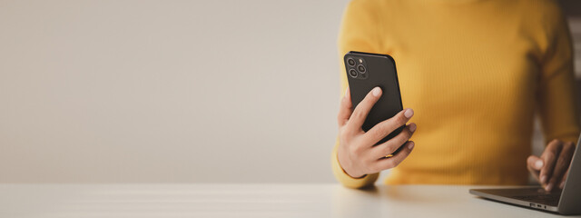 A person holds a mobile phone to use social media on a smartphone, communicating via the Internet...