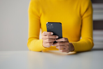 A person holds a mobile phone to use social media on a smartphone, communicating via the Internet on a smartphone. The concept of using technology in communication.