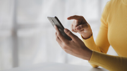 A person holds a mobile phone to use social media on a smartphone, communicating via the Internet on a smartphone. The concept of using technology in communication.