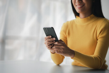 A person holds a mobile phone to use social media on a smartphone, communicating via the Internet on a smartphone. The concept of using technology in communication.