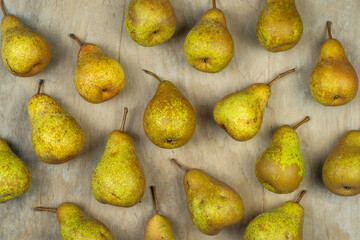 Pears on a wooden background. Fruit harvest. Autumn still life. Pear variety Bera Conference. Vitamin food.