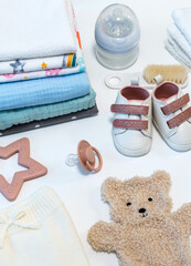 Set of baby shoes, toys and accessories on white background. Newborn stuff. Flat lay, top view