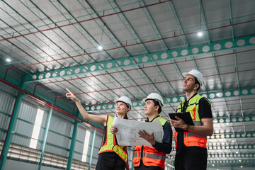 Team engineers workers planning and talking in empty warehouse to design the arrangement of product...
