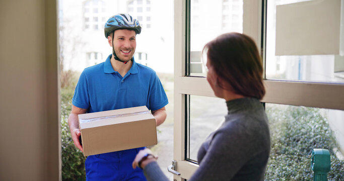 Happy Young Woman Accepting Parcel Box