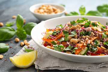 Asian Quinoa salad with fresh vegetables, peanuts and herbs. Healthy food.