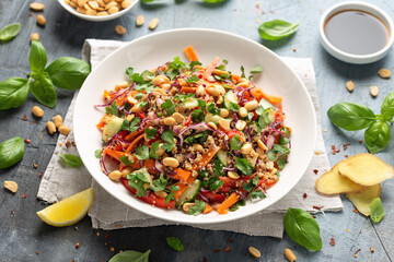 Asian Quinoa salad with fresh vegetables, peanuts and herbs. Healthy food.