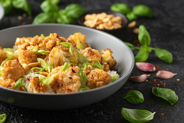 Kung Pao Cauliflower with rice, peanuts and spices. Healthy vegan food.