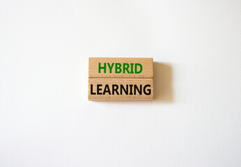 Hybrid learning symbol. Concept word Hybrid learning on wooden blocks. Beautiful white background. Business and Hybrid learning concept. Copy space