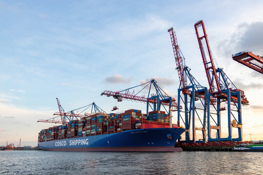 Huge chinese container ship Virgo from Cosco Shipping in the harbour of Hamburg on 14.04.2023, 400m long, sunset shot.
