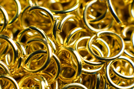 Small golden metal hoops. Background, wallpaper, metallic texture.