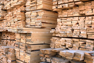 A large warehouse of wooden boards of various sizes for construction.