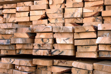 Close-up of a warehouse of wooden boards of various sizes for construction.