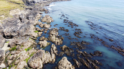 coast of the Atlantic Ocean in Ireland, top view. Rocky coast, seaside landscape. Irish nature, gray rocky mountain.