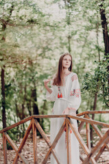 Ukrainian national ethnic costume. Woman walks outdoor, hope. Rustic, village