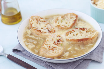 A ceramic bowl with French onion soup