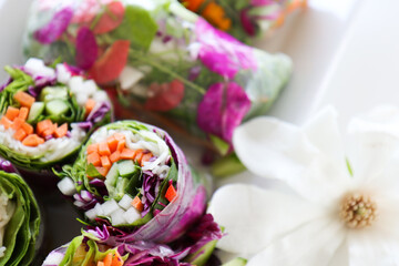 Summer Rolls on white plate, close up with  flower