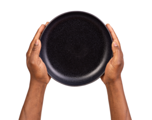 Man holding an empty black plate isolated on white or transparent background, top view